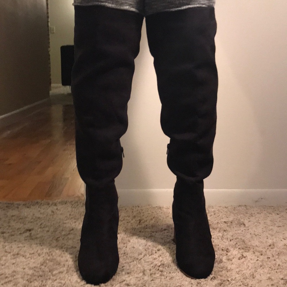 Black over the knee boot with tan block heel.